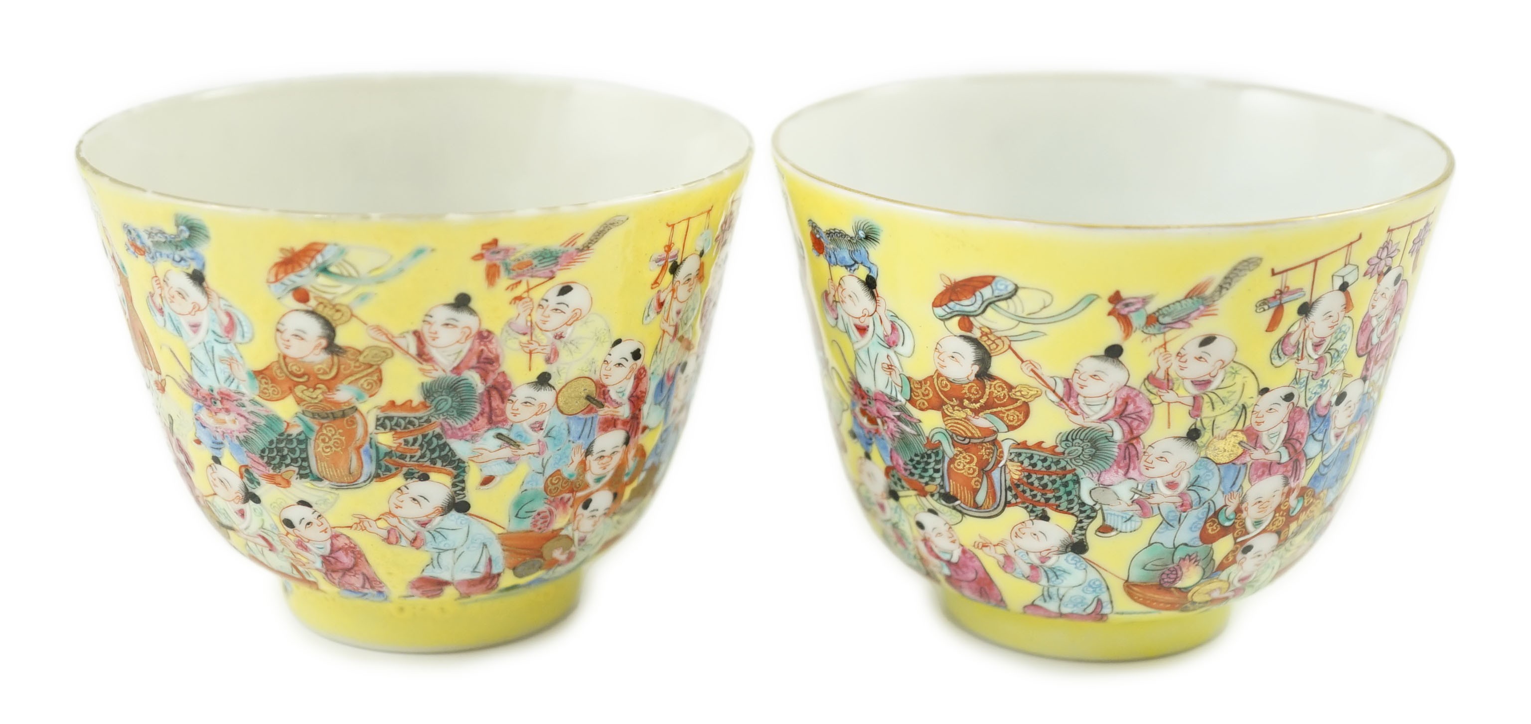 A pair of Chinese yellow ground 'Hundred Boys’ cups, 19th century, 6.5cm high 8.5cm diameter